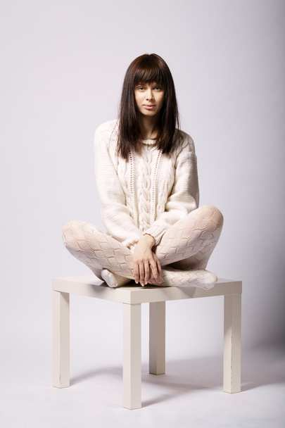 young girl sitting on small table - Foto, Imagem
