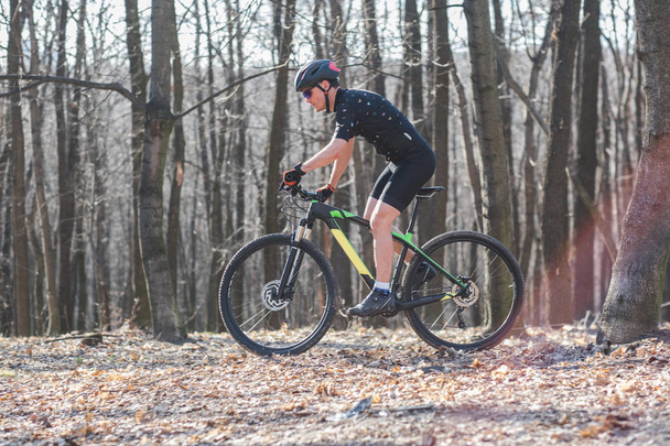 mužské sportovce mountainbiker s kole po lesní stezce. v lese mlha - Fotografie, Obrázek