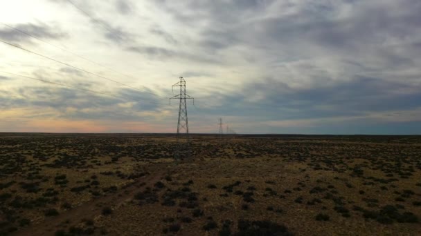 Vzdušný pohled na vysokonapěťové elektrické a elektrické vedení při západu slunce. Pamáska v Patagonii, Argentina, Jižní Amerika - Záběry, video