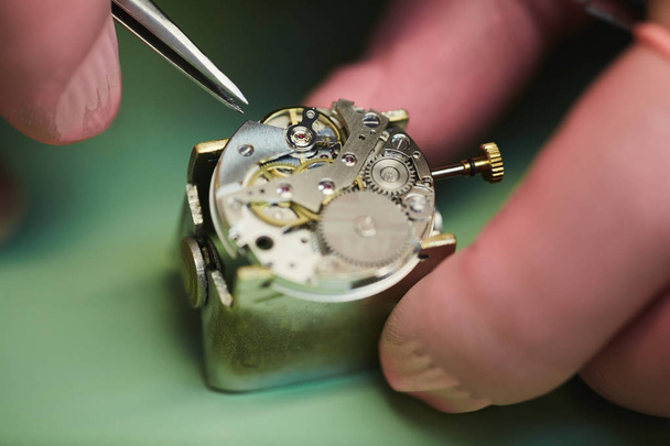 Extreme macro shot of unrecognizable man assembling mechanical watch, copy space - Photo, Image