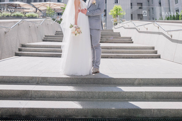 bride and groom on the big staircase - Fotó, kép