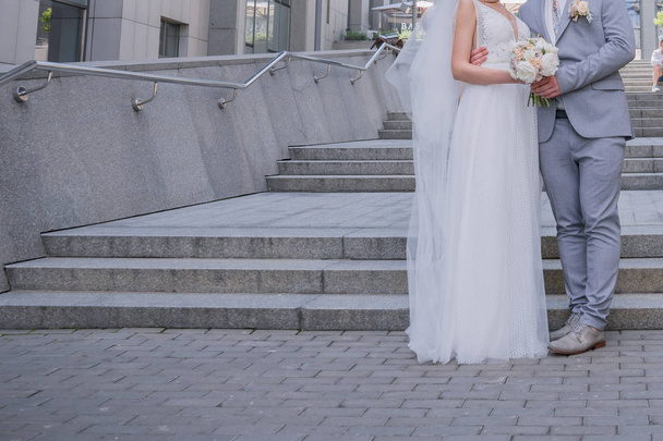 bride and groom on the big staircase - Fotó, kép