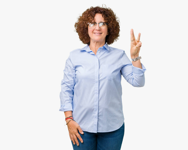Beautiful middle ager senior businees woman wearing glasses over isolated background showing and pointing up with fingers number three while smiling confident and happy. - Photo, Image