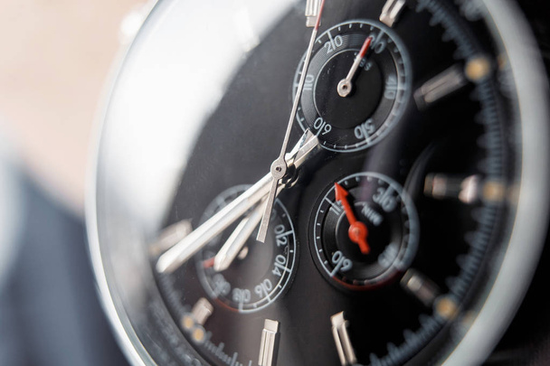 Close up front view of a modern wrist watch on the table. Soft focus.  - Φωτογραφία, εικόνα