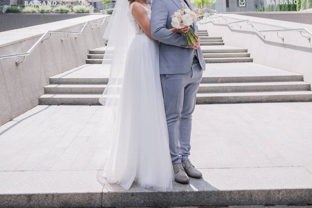 bride and groom on the big staircase - Zdjęcie, obraz