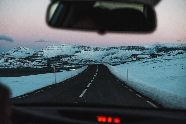 View from car on road in countryside at sunset in Iceland - 写真・画像