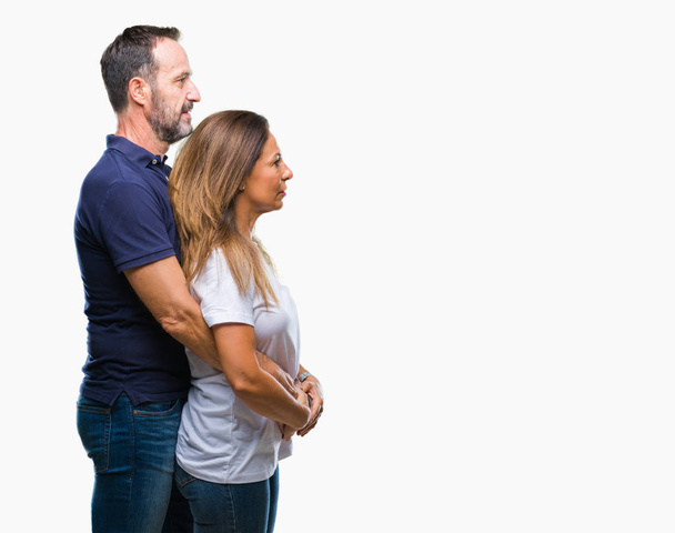 Middle age hispanic casual couple over isolated background looking to side, relax profile pose with natural face with confident smile. - Fotoğraf, Görsel