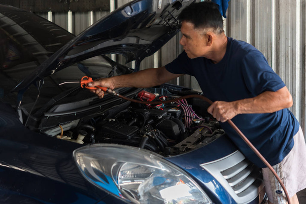 Checking a car engine for repair at car garage - Foto, immagini