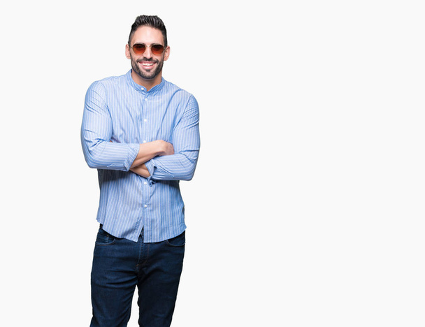 Young handsome man wearing sunglasses over isolated background happy face smiling with crossed arms looking at the camera. Positive person. - Photo, Image
