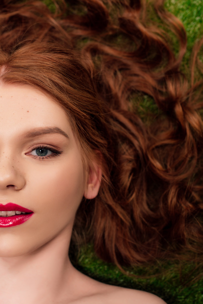 top view of beautiful young redhead woman with red lips looking at camera - Foto, Bild