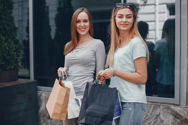 Cute girls with shopping bag in a city - Zdjęcie, obraz
