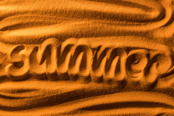 top view of word summer written in sand with smooth waves and color filter - Фото, изображение