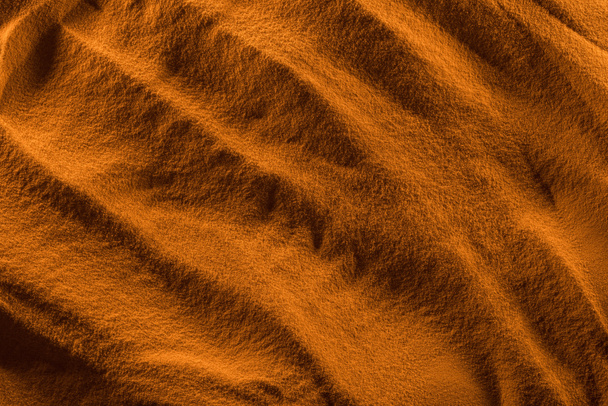 滑らかな波とオレンジ色のフィルターとテクスチャ砂の上面図 - 写真・画像