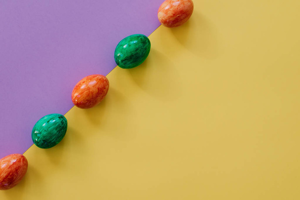 Easter eggs on yellow background. - Foto, afbeelding