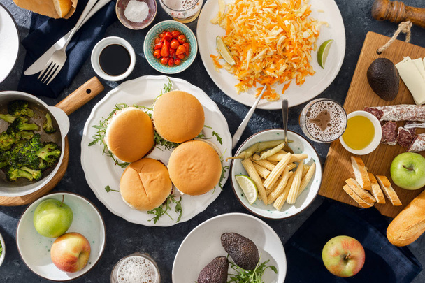 Vegetarian burgers with different foods. Vegetarian food is not only. Summer party food concept top view. Various food on table flat lay - Foto, immagini