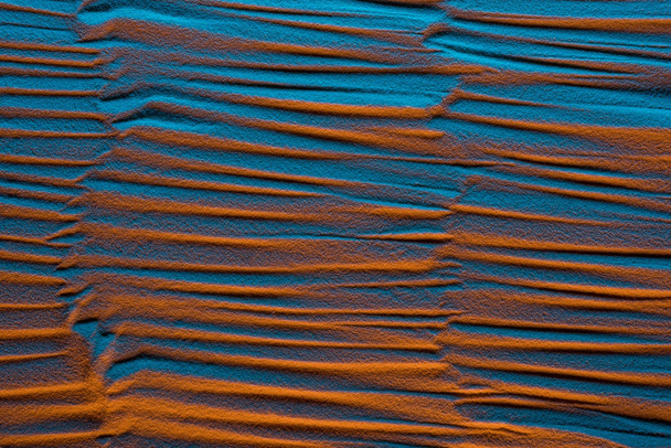 top view of textured sandy background with color filter and abstract waves - Photo, Image