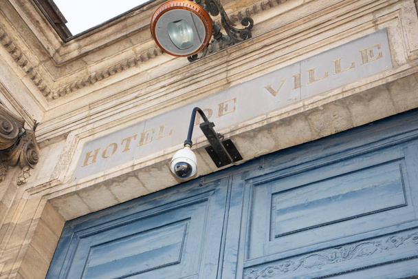 White round CCTV camera on hotel de ville, means city hall, in bordeaux France wall - Photo, Image