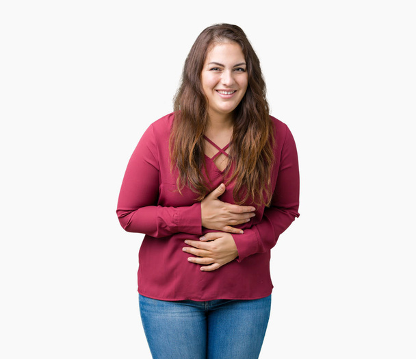 Beautiful plus size young woman over isolated background Smiling and laughing hard out loud because funny crazy joke. Happy expression. - Photo, Image