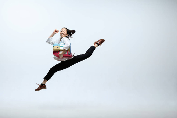 Woman working at office and jumping isolated on studio background - Fotoğraf, Görsel