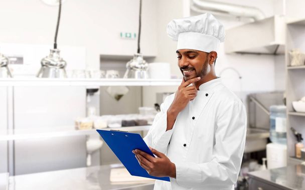 indian chef with clipboard at restaurant kitchen - Photo, Image