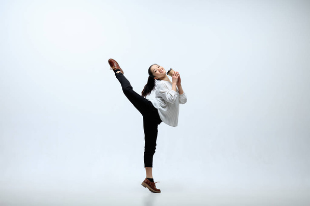 Woman working at office and jumping isolated on studio background - Foto, Imagem