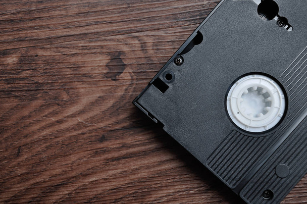 A video cassette isolated on a wooden background - Zdjęcie, obraz