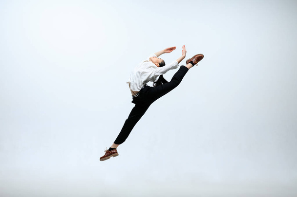 Woman working at office and jumping isolated on studio background - Fotó, kép