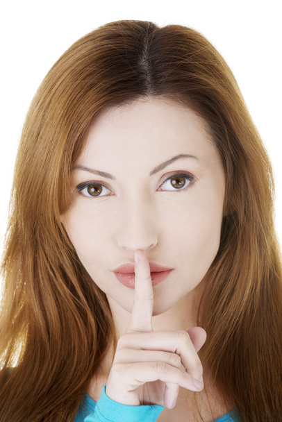 Woman with finger on her lips. - Foto, Imagen