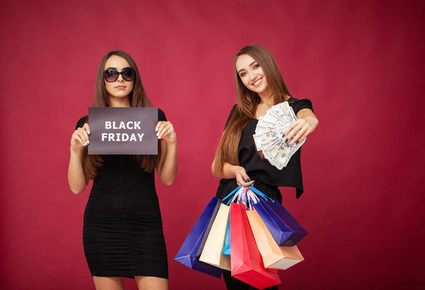 Einkaufen. elegante brünette Frauen tragen schwarzes Kleid mit Einkaufstaschen, Black-Friday-Konzept - Foto, Bild