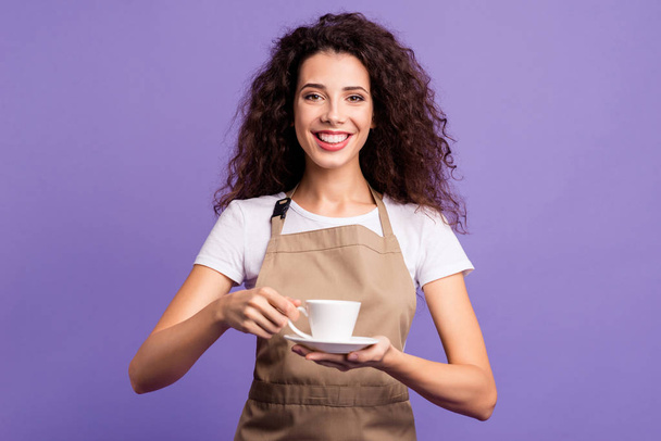 Close up photo amazing beautiful her she lady cafeteria hold hands arms glass cup hot fresh beverage invite guests little rest relax wear casual white t-shirt apron isolated violet purple background - Foto, Imagen