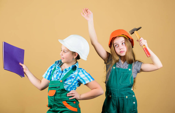 Little kids in helmet with tablet and hammer. small girls repairing together in workshop. happy children. Future career. Labor day. 1 may. Foreman inspector. Repair. working day. ordinary working day - Photo, image