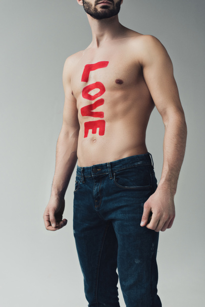 Cropped view of man shirtless man with inscription on body isolated on grey - Photo, Image