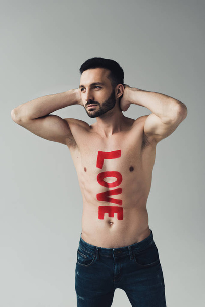 Shirtless bearded man with inscription on body isolated on grey - Foto, imagen