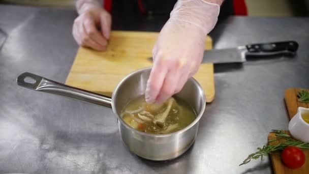 Chef adding ingredients in the soup - Filmati, video