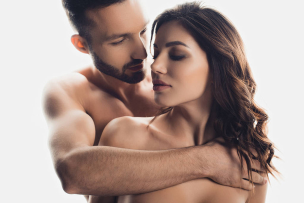 handsome bearded man embracing nude girlfriend isolated on white - Zdjęcie, obraz