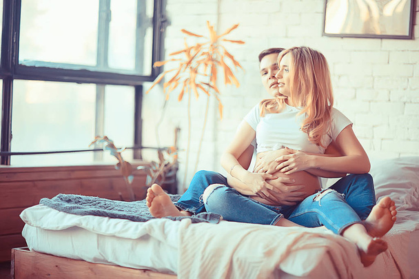 concept family pregnancy home comfort / husband and pregnant wife with a big belly in a cozy home environment - Φωτογραφία, εικόνα