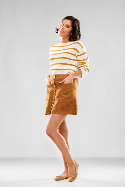 young woman in striped pullover, skirt and shoes - Фото, зображення