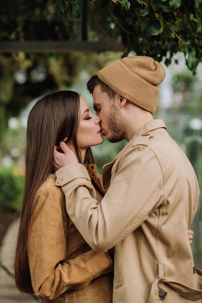 happy lovers boyfriend and girlfriend kissing, hugging in the garden - Foto, afbeelding