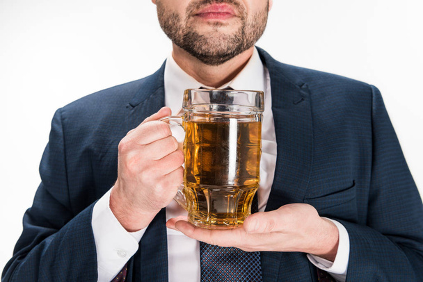 cropped view of chubby man in formal wear holding glass of beer on white - Fotoğraf, Görsel