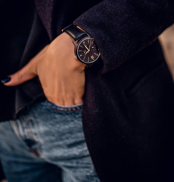 Stylish trendy black watch on woman hand - Фото, зображення