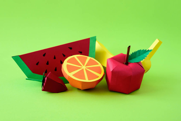Apple, strawberry, banana, orange and watermelon made from paper on green background. Fresh fruits. Minimal, creative, vegan, healthy or food art concept. Copy space. - Foto, Bild