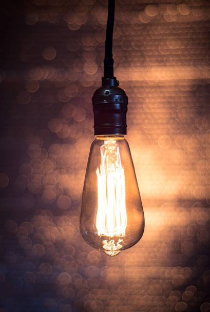 Old vintage Edison bulb on blurry background - Photo, Image