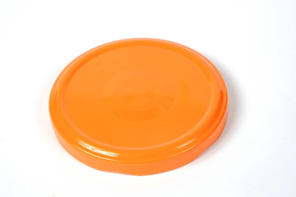 Screw cap for glass jars. For canning, canned food. Orange cap on white background - Photo, Image
