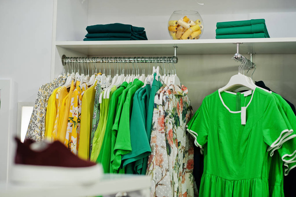 Female green colorful clothing set of on the racks and shelves i - Zdjęcie, obraz