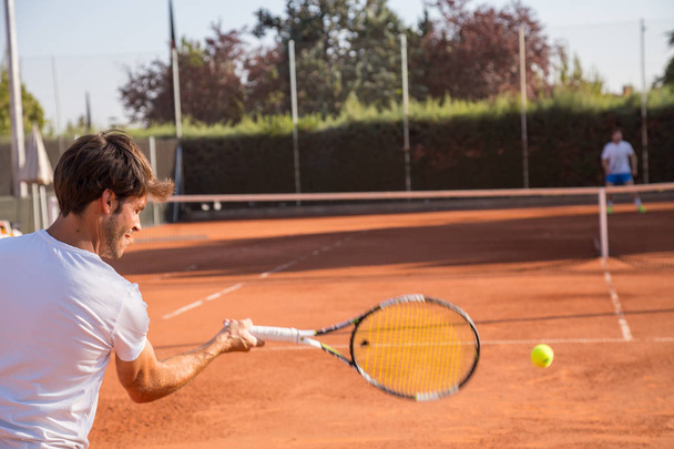 Professional tennis player man playing on court in afternoon. - Photo, Image