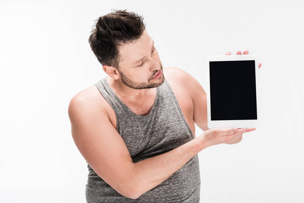 sobrepeso hombre mostrando tableta digital con pantalla en blanco aislado en blanco
 - Foto, imagen