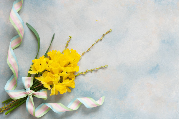 Spring bouquet with yellow narcissus on the blue sky background - Photo, image