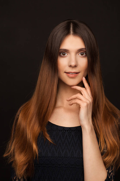 Portrait of a beautiful woman with straight long hair and interesting emotion. Studio photo session - Valokuva, kuva