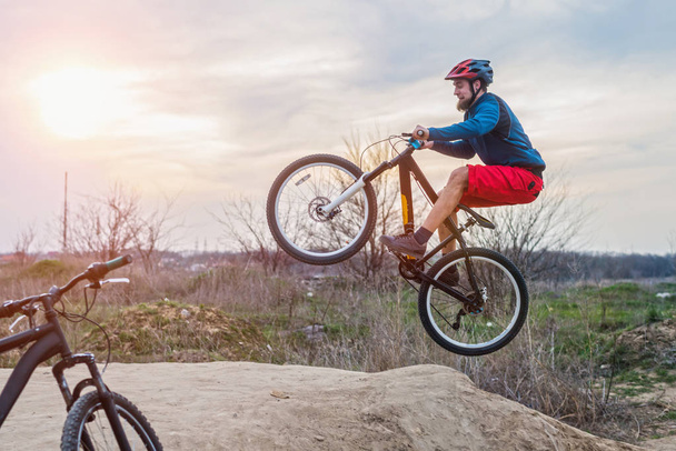 A man on a mountain bike performing a dirt jump. Active lifestyle. - Photo, Image