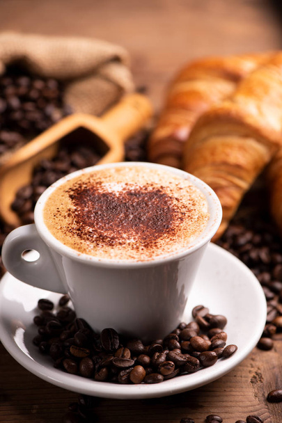 Чашка кофе в окружении кофейных зерен
 - Фото, изображение